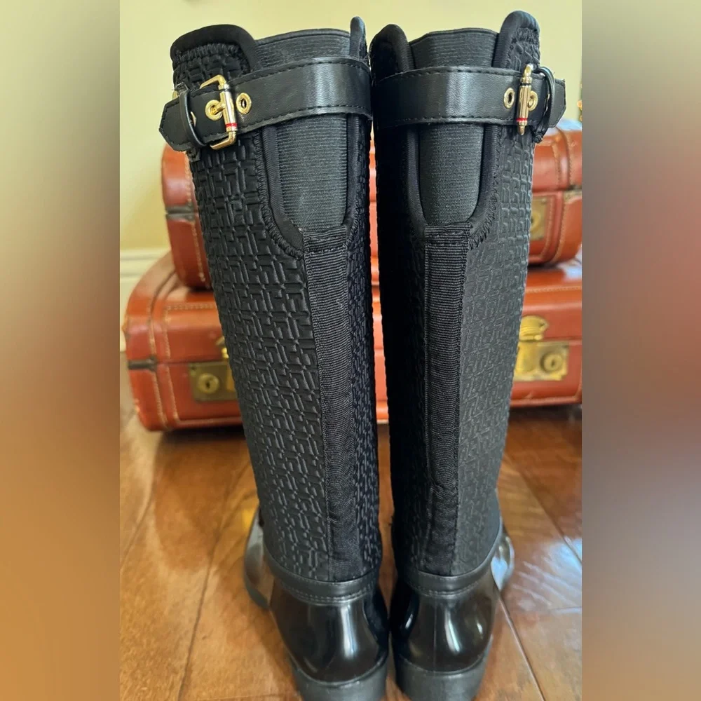 Tommy Hilfiger Black Boots. Gold accent hardware, logo embossed fabric.